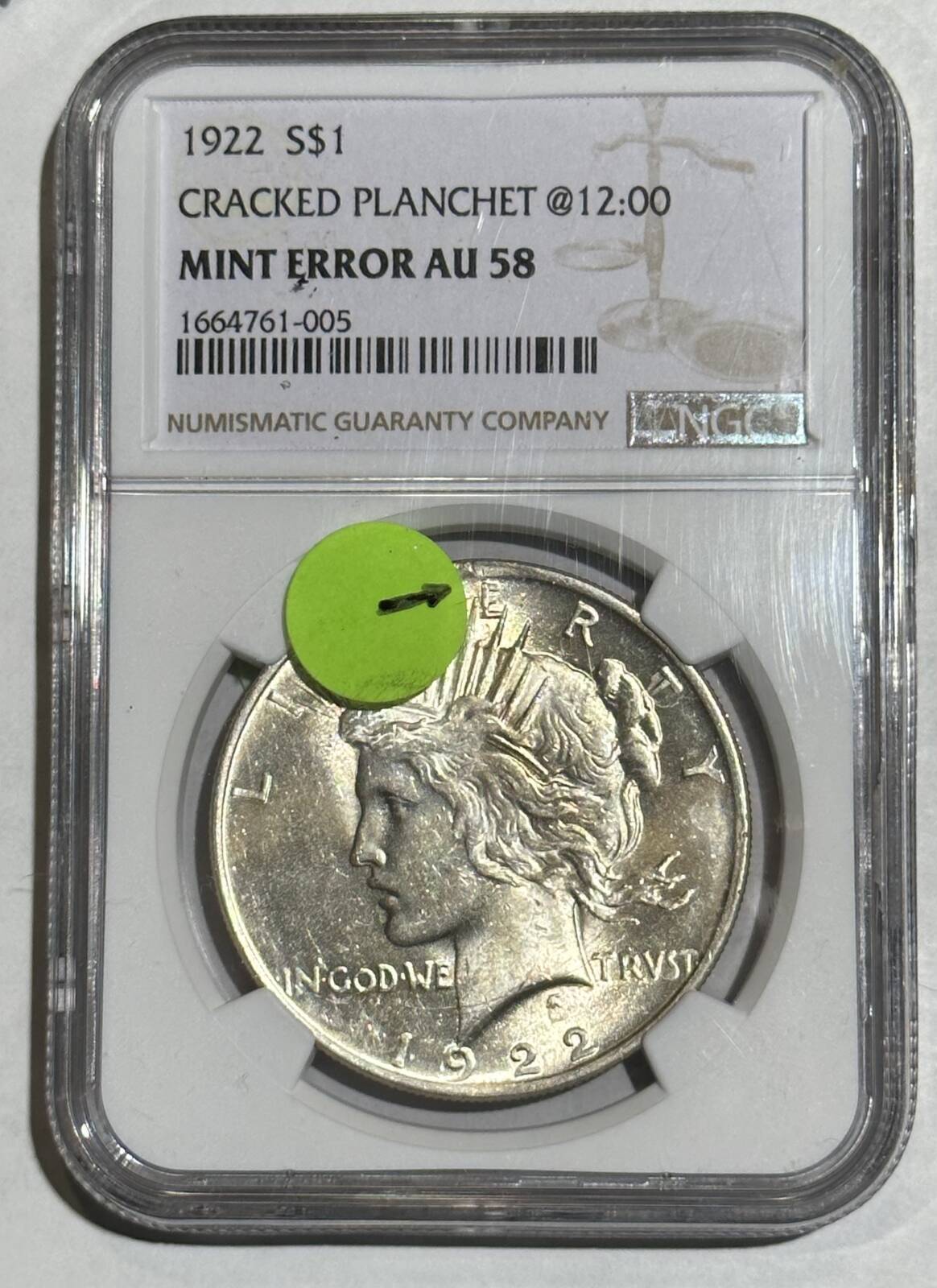 NGC Certified AU58 1922 $1 Cracked Planchet Mint Error with sticker indicating the error