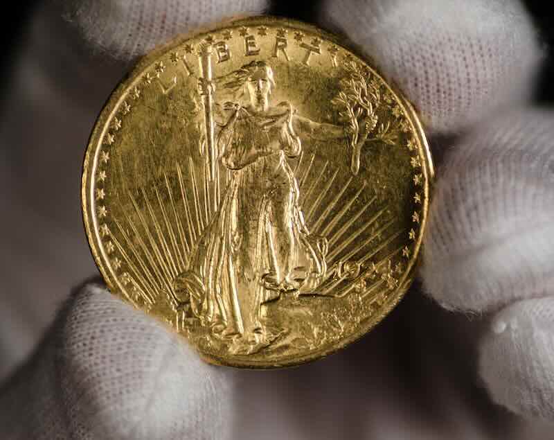 1924 St Gaudens $20 Double Eagle coin held by a white gloved hand