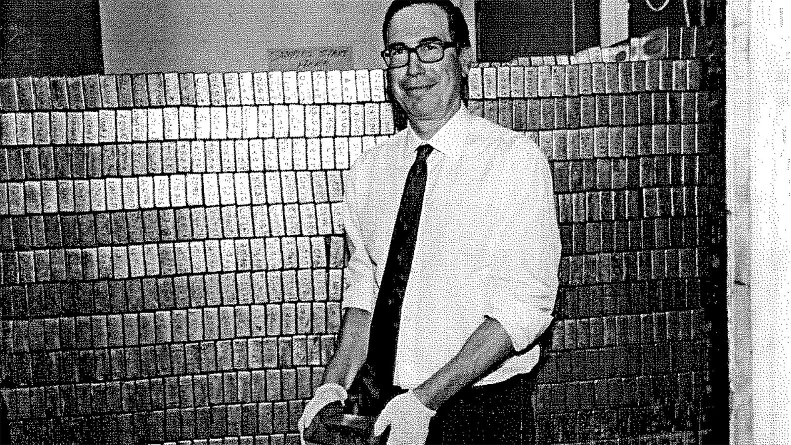 Treasury Secretary Steve Mnuchin holding a gold bar at Fort Knox