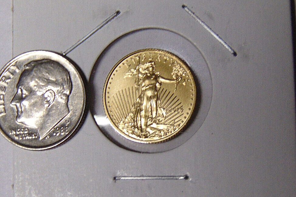 ten cent (dime) coin next to a 1/10 oz Gold American Eagle